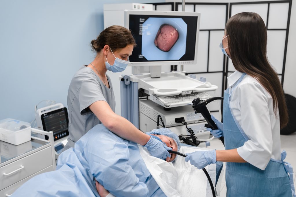Laparoscopy Training Program doctor using a fiberoptic scope at gastroscopy in modern operating room.